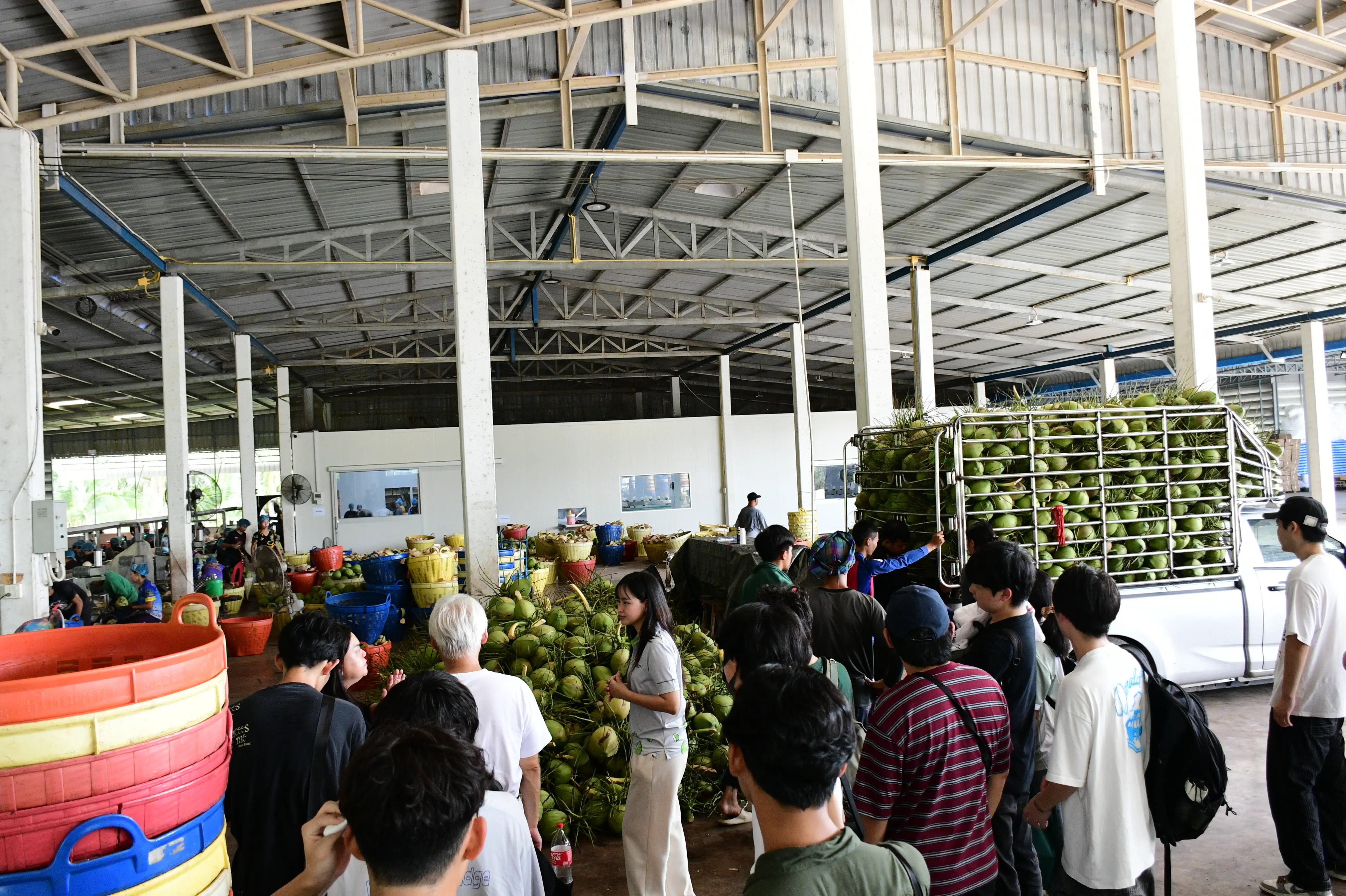 Students observing the in-factory processing line through the viewing window